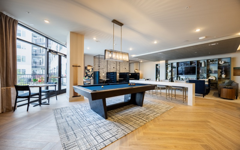 a room with a billiards table and seating